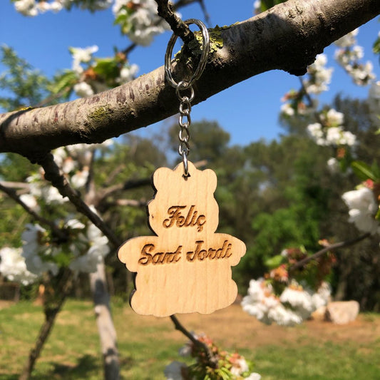 Llavero de madera con forma de dragón de Sant Jordi grabado a láser en la cara posterior con la frase Feliç Sant Jordi