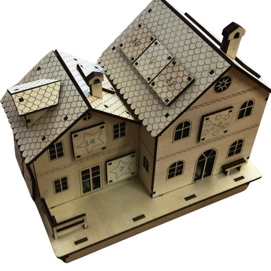 Calendario de adviento de madera en forma de casa con distintos compartimentos de madera estilo cajón donde guardar la sorpresa de cada día