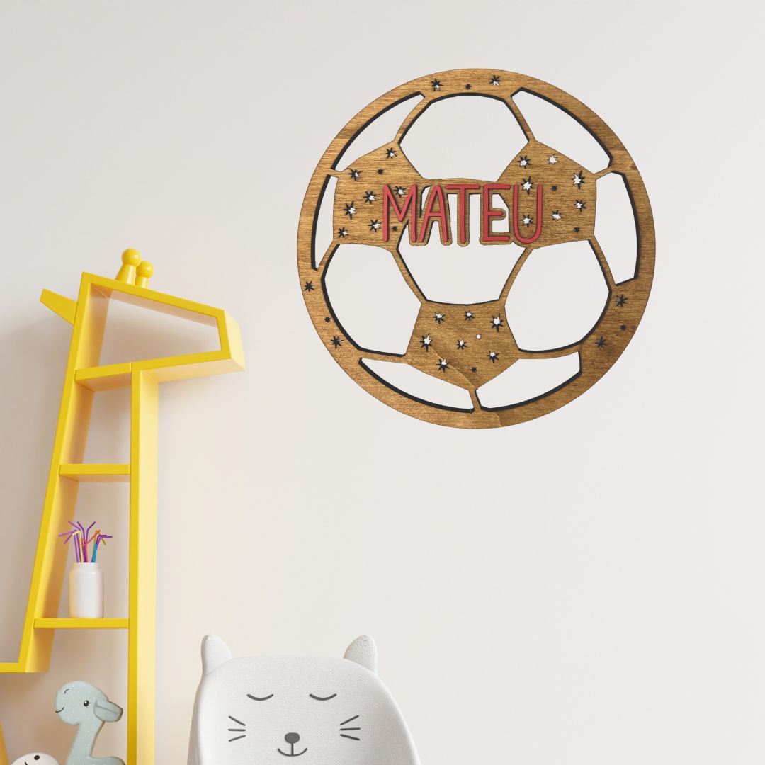 Placa de madera para colgar en la habitación infantil simulando una pelota de fútbol con el nombre del niño en madera de color.