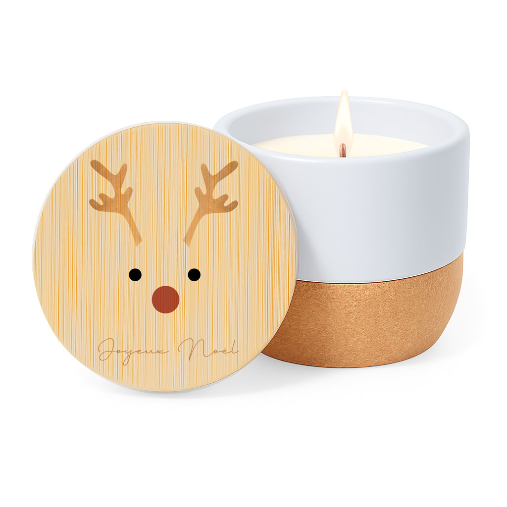 Vela aroma de lino con tarro de cerámica y base de corcho. Tapa de bambú con dibujo minimalista de un reno y la frase Joyeux Noel