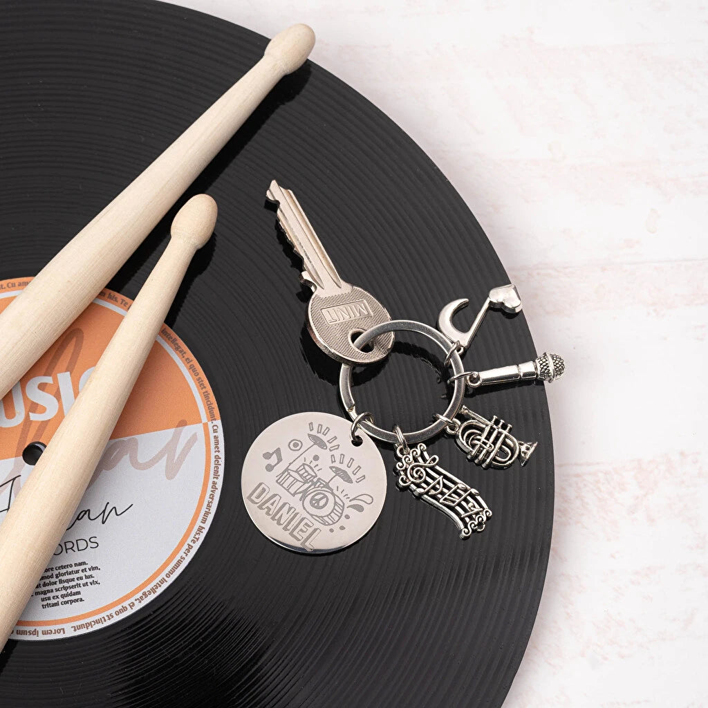 Llavero de acero inoxidable con chapa grabada y charms temáticos: música. Personalizable con grabado láser desde 1 unidad. Ideal como regalo original.